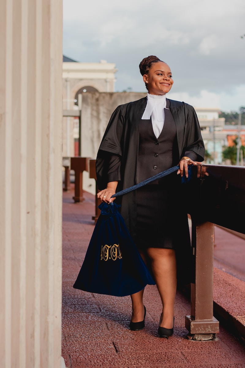 a woman in a black dress holding a blue bag